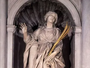 St Bibiana by Bernini, a marble statue of a woman in a shell-topped niche, gazing upward with one hand raised and holding golden fronds.