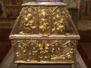 Sant Cugat Casket with gilded figures and arched scenes on a silver-colored metal casket