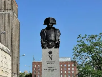 Napoleon Bonaparte monument in Warsaw, showing a bronze bust on a tall stone plinth.