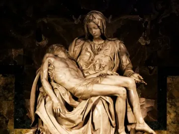 Pietà marble sculpture of Mary cradling the body of Jesus across her lap