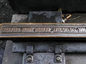 Close-up of the inscription plaque on Trains to Life – Trains to Death