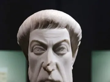 Marble bust of Eutropius with a stern expression, short cropped hair, and a textured beard and mustache.