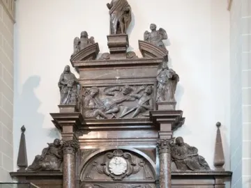 Tomb of Lew Sapieha, a tall ornate marble monument with carved figures, relief panels, and a standing figure at the top