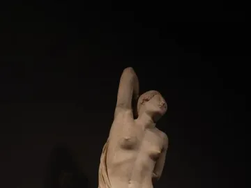 Niobid from the Gardens of Sallust, a marble sculpture of a kneeling female figure with one arm raised above her head.