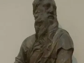 The Sacrifice of Isaac sculpture showing an older bearded man restraining a kneeling younger man with a blade.