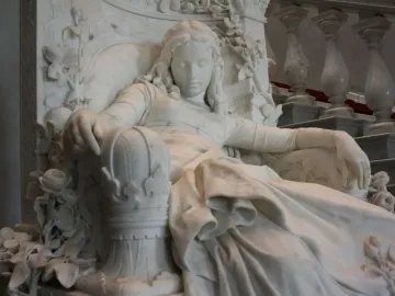 Sleeping Beauty marble sculpture of a resting woman in an ornate carved chair