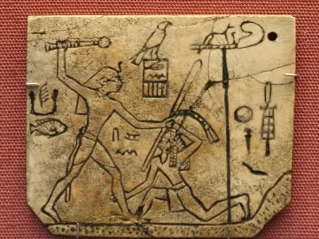 MacGregor plaque showing a cracked ivory carving of a standing figure raising a mace over a kneeling figure, with hieroglyphs and a standard.
