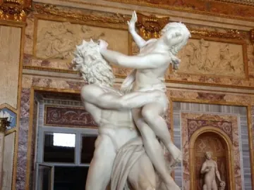 The Rape of Proserpina marble sculpture showing a bearded man lifting a resisting woman in a dramatic struggle.