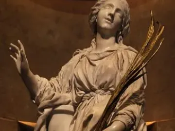 St Bibiana marble sculpture gazing upward, with one hand raised and the other holding golden fronds.