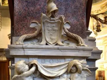 Tomb of Ferdinand van den Eynde with winged putti holding a draped banner above an inscribed marble plaque.