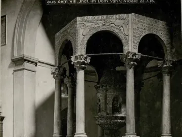 The Baptistry of Callistus, showing an octagonal stone baptistery with slender columns, arched openings, and a carved baptismal font inside.