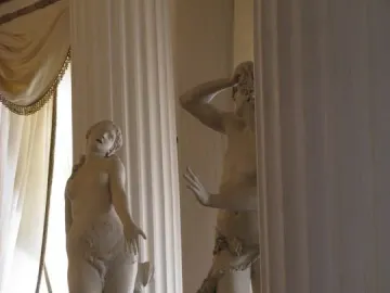 Orfeo y Eurídice marble sculpture with Eurydice reaching upward and Orpheus covering his head.