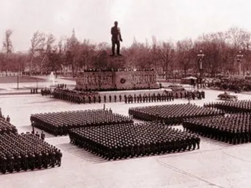 Stalin Monument overlooking a large parade formation in a public square.