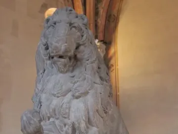 Marzocco, a stone lion sculpture holding a shield with a fleur-de-lis emblem