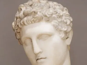 Hermes Belvedere marble sculpture showing the head and upper torso with curly hair and a draped shoulder.