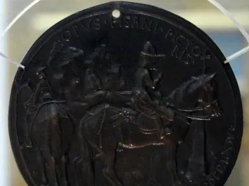 Reverse of the Medal of John VIII Palaiologos, showing a circular bronze relief with figures on horseback and inscriptions around the edge.