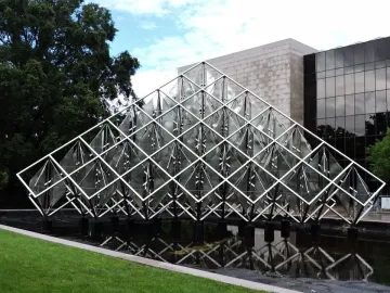 Delta Solar, a large silver geometric sculpture with fan-like elements above a reflective pool.