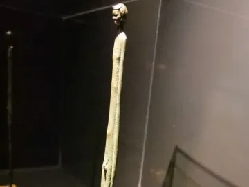 Ombra della Sera bronze figure with an elongated body displayed in a glass case