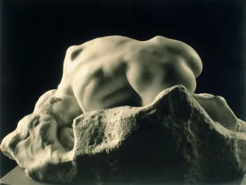 Rodin’s Danaid, a marble nude female figure bent over a rough stone base with her head resting against it.