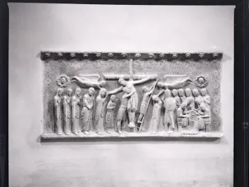 Marble relief of the Descent from the Cross with a crowded scene of figures surrounding the lowered body of Christ.