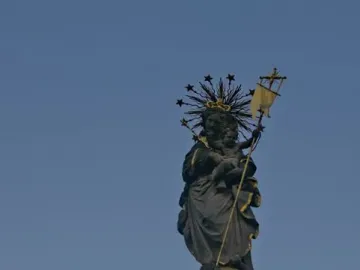 Kornmarkt Madonna sculpture of a crowned woman holding a child, standing on a globe above an ornate base with cherubs.