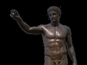 Antikythera Ephebe, a dark bronze nude male youth statue with short curly hair and one arm extended, on a light base against a black background.
