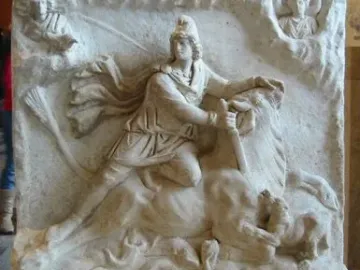 Mithras of Fiano Romano relief showing a bull-slaying scene above a banquet scene with several figures around an altar.