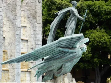 Monumento del Ángel bronze sculpture with a standing figure holding a sword above a winged figure in Santa Cruz de Tenerife.