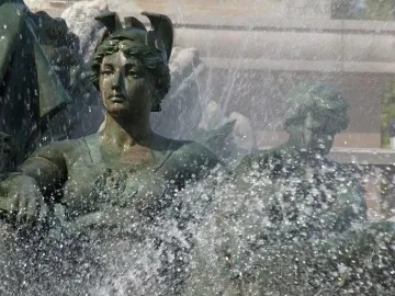 Bronze statue from the Monument aux Girondins, with a woman looking upward as water sprays around her.