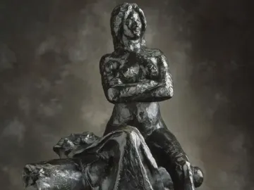 The Resistance sculpture of a nude woman seated with crossed arms and an upward gaze.