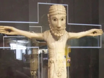 Carrizo Christ, a carved figure of Christ with outstretched arms, beard, braided hair, and a waist garment.