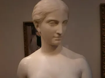 California, a white marble bust of a woman with classical hair and a serene expression on a pedestal.