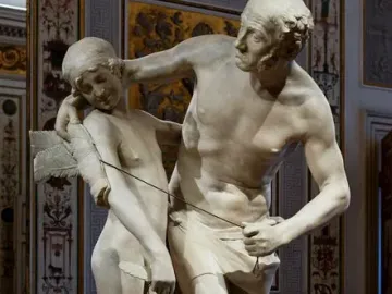 Daedalus and Icarus marble sculpture showing an older bearded man embracing a winged nude youth while fastening the wings with cords.