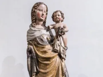 Friesentor Madonna, a weathered painted wooden sculpture of the Madonna holding the infant Jesus on her hip.