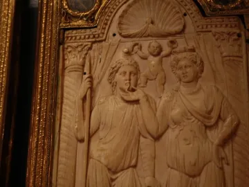 Queriniano Diptych with a classical relief carving of two figures and a cherubic figure above them