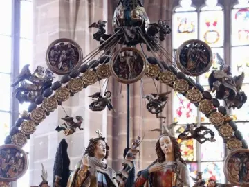 Angelic Salutation carved wooden sculpture with an angel and a woman inside an ornate circular frame