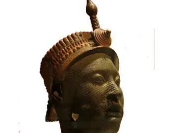 Bronze Head from Ife with a striated facial surface and ornate headpiece topped by a spiraled finial.