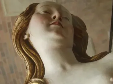 Detail of a wooden sculpture of Mary Magdalene.