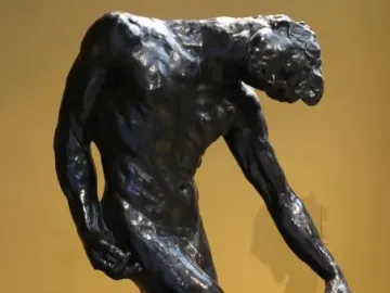 The Three Shades bronze sculpture by Auguste Rodin, showing a bowed figure on a rocky base.