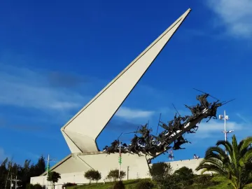 Vargas Swamp Lancers monument with white triangular structure and dark horsemen charging uphill