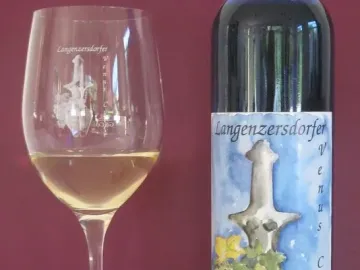 Wine bottle and glass featuring the Venus of Langenzersdorf on the label and etched onto the glass
