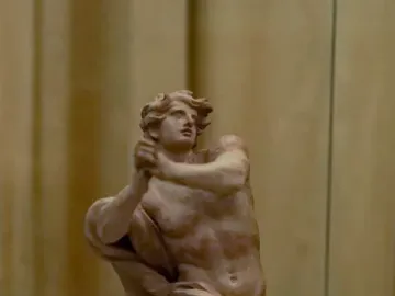 Bernini’s Daniel and the Lion sculpture model showing a muscular figure with raised arms standing over a crouching lion.