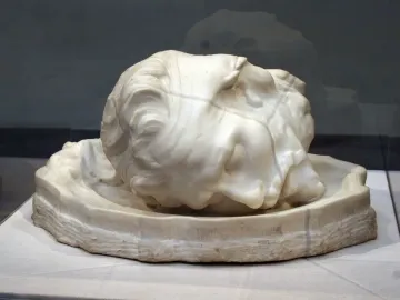 Stone sculpture of the head of Saint John the Baptist resting in a shallow basin