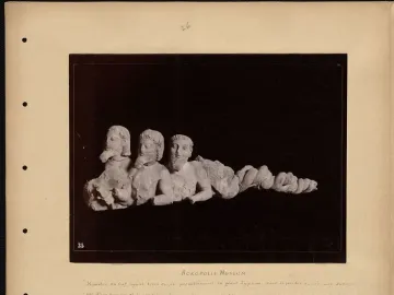 Trisomatos Typhon sculpture with three conjoined bearded male torsos and a coiled serpentine lower body.