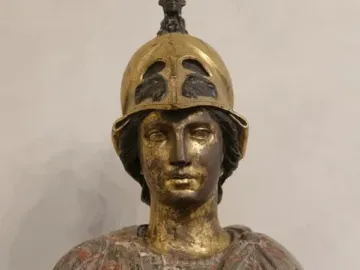 Bust of Athena Giustiniani with a gilded female head and helmet above a mottled marble torso with drapery and a Medusa head.