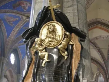 Memorial to Maria Raggi with a central medallion, two golden putti, and a cross on a church pillar