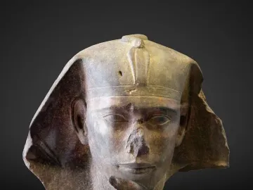 Damaged stone head of Djedefre sphinx with a royal headdress and missing nose