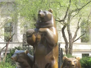 Group of Bears sculpture with three bronze bears on a tiered base in Central Park.