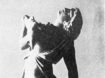 Dancing Maenad statue in a dramatic twisting pose with arms raised and head thrown back.