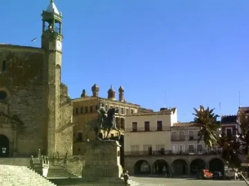 Francisco Pizarro equestrian statue on a stone pedestal in a sunlit square.